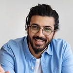 Smiling man in glasses and a blue shirt, conveying a friendly demeanor, relevant to Star Contractor's service-oriented business approach.
